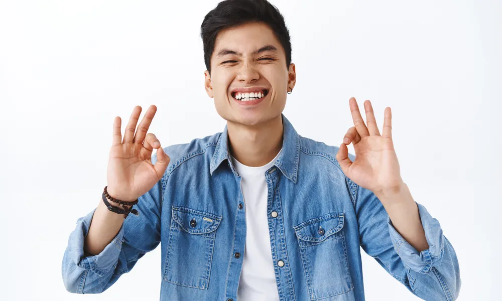 close-up-portrait-charismatic-attractive-asian-man-guarantee-best-quality-recommend-product-laughing-smiling-pleased-being-assertive-you-will-like-it-white-wall