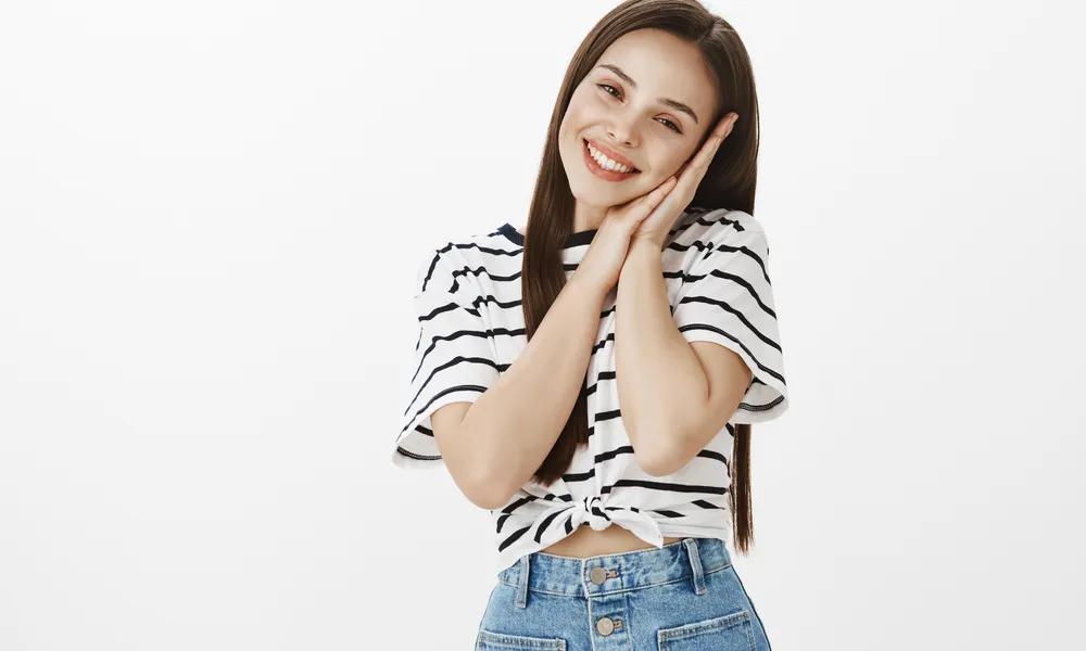 dreamy-attractive-romantic-young-woman-leaning-palms-daydreaming-with-lovely-smile