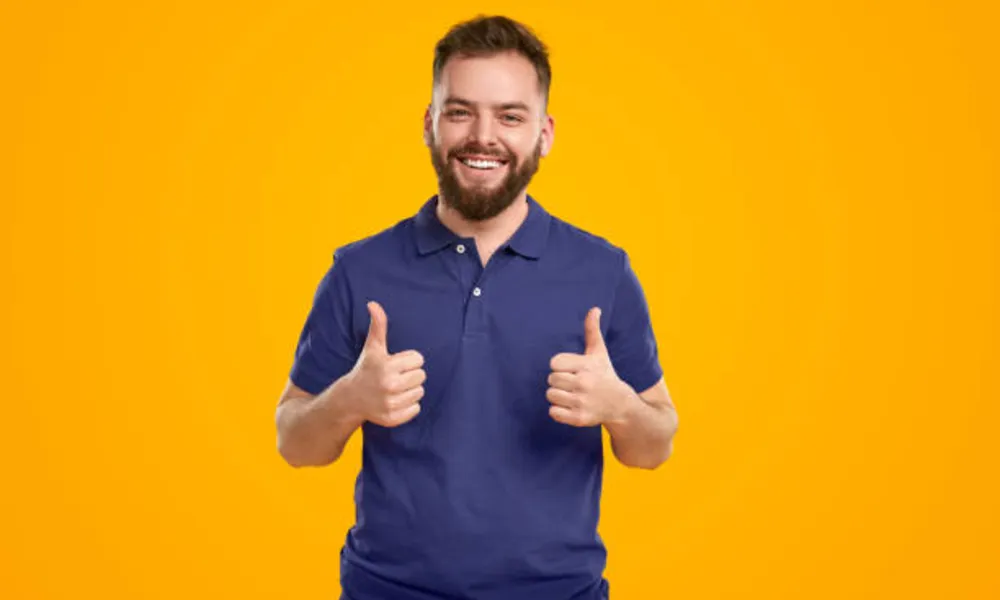 happy-man-showing-thumbs-up-in-studio