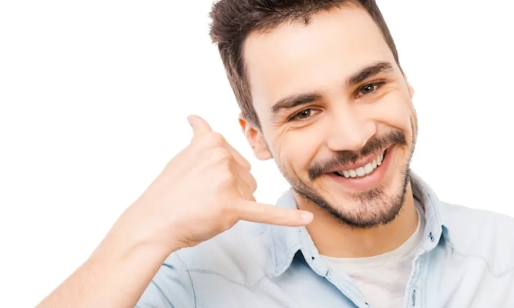 waiting-your-call-confident-young-man-shirt-gesturing-mobile-phone-near-his-face-smiling-while-standing-against-white-background_425904-23981